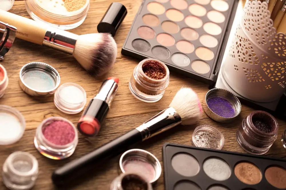Desk full of open makeup containers